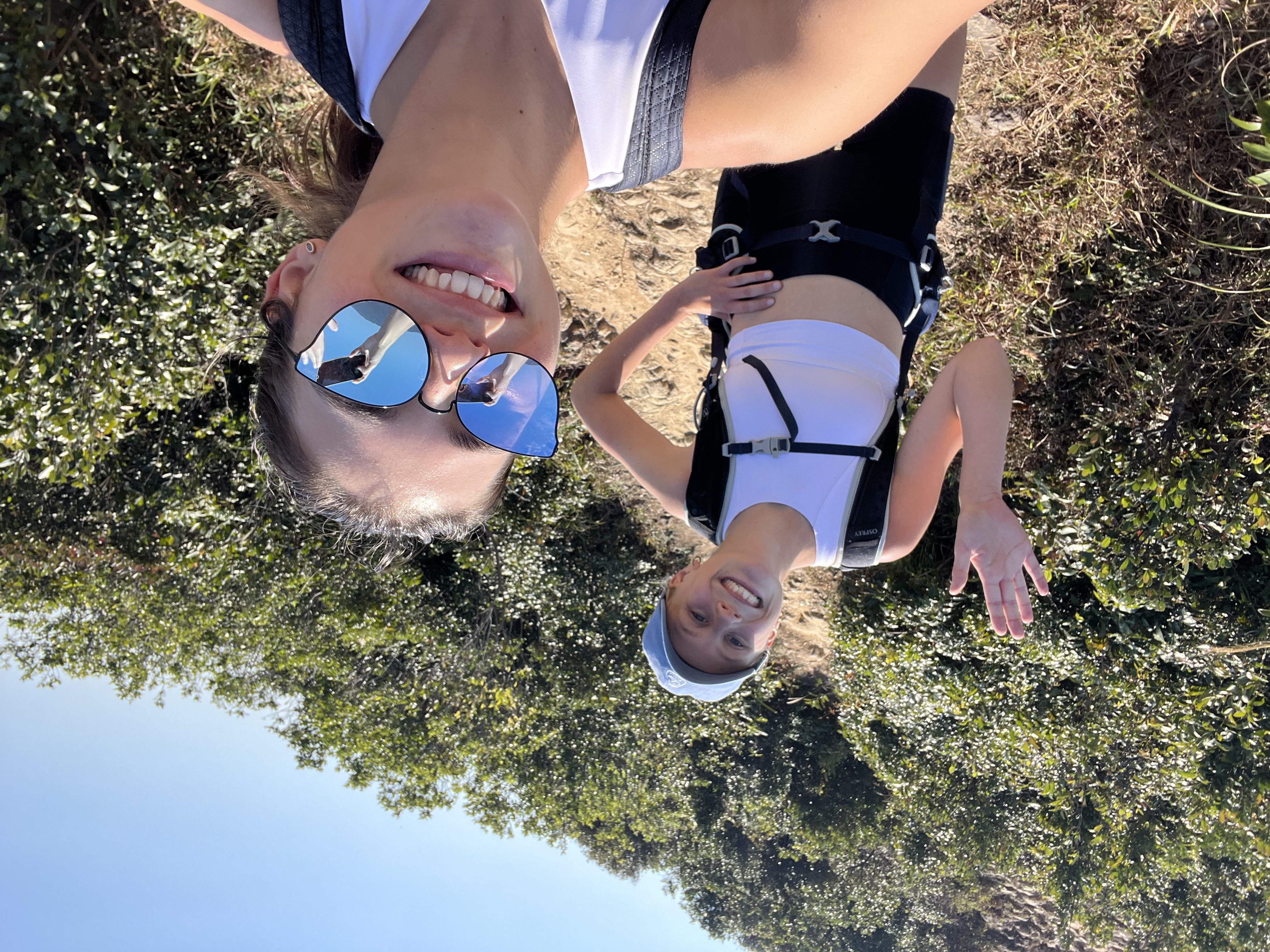 Two girls posing for a selfie on a hike up the mountain