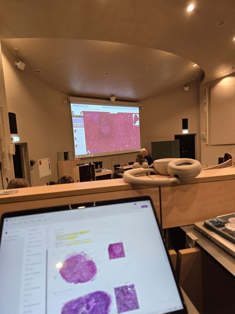 laptop with images of immune cells in a lecture hall