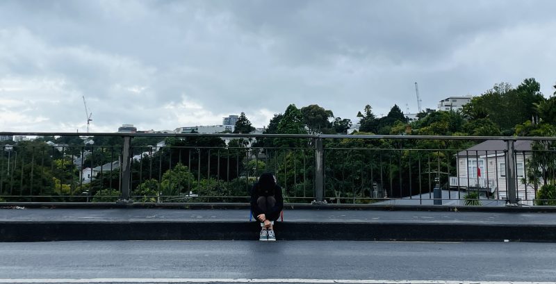 Sitting along an empty road in the rain