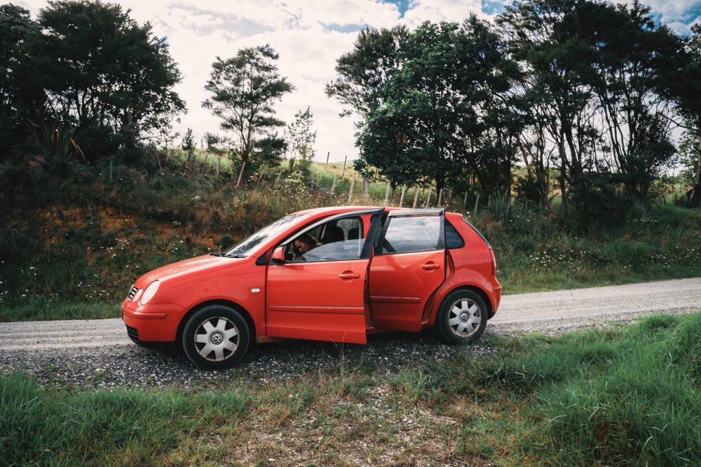 A red old car we rented from friends of friends, pulled over by the road. 