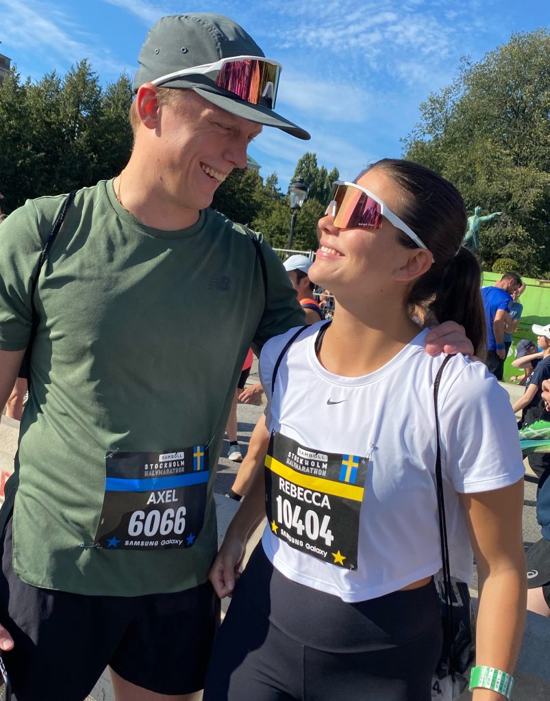 Me and my partner looking at each other, dressed in work-out gear prior to a half-marathon.