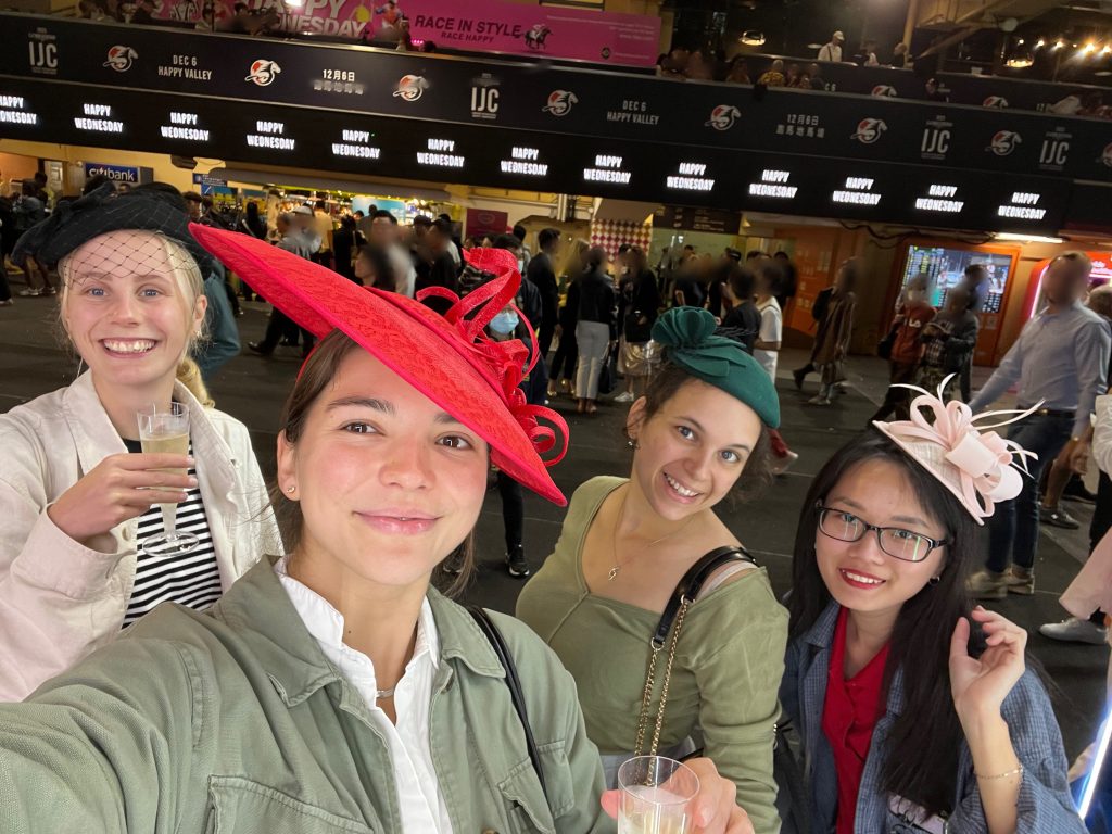 Four girls posing in funny hats