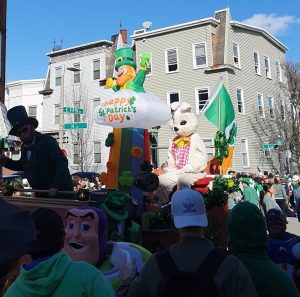 Float saying "Happy Saint Patrick's Day" withh a leprechaun and a bunny on it.