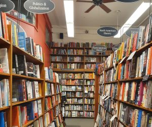 Books on shelves forming aisles and lining the walls.