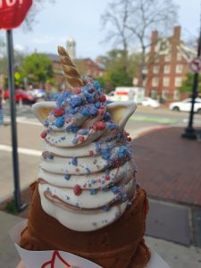 Soft serve ice cream in a fish-shaped cone with a unicorn horn and ears.