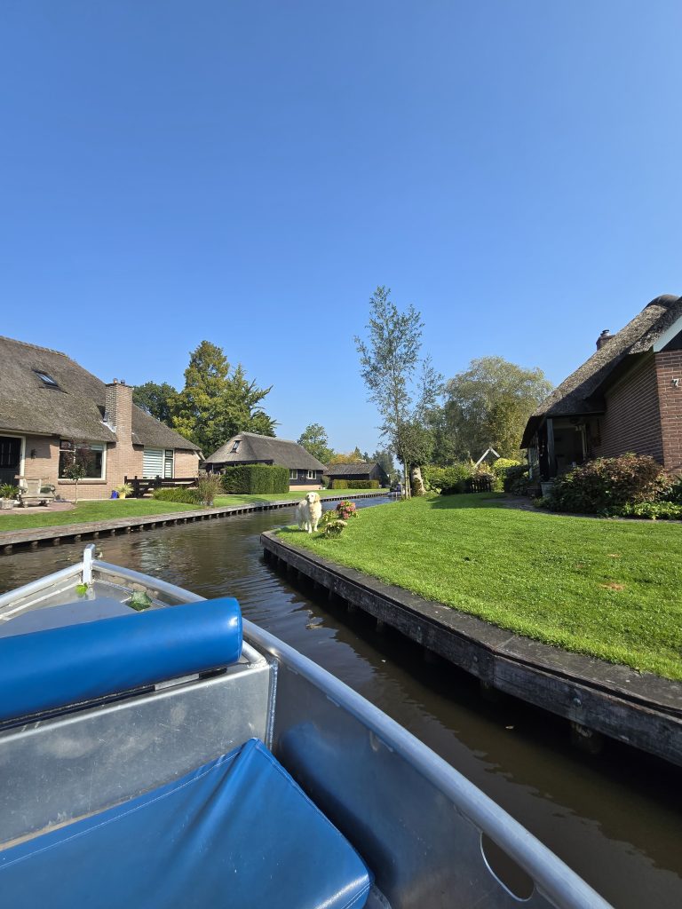 canal going through a neighborhood with thatched-rood cottages