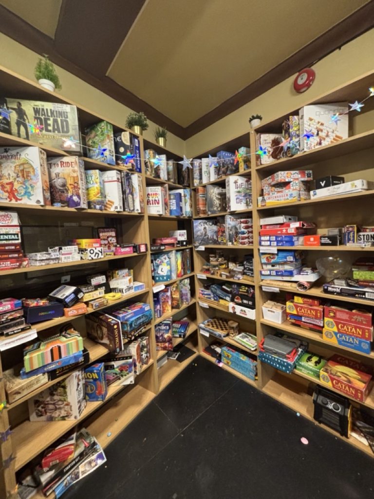 A large set of shelves full of multicolored board games